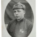 Red Army soldier with badges and Budyonovka hat